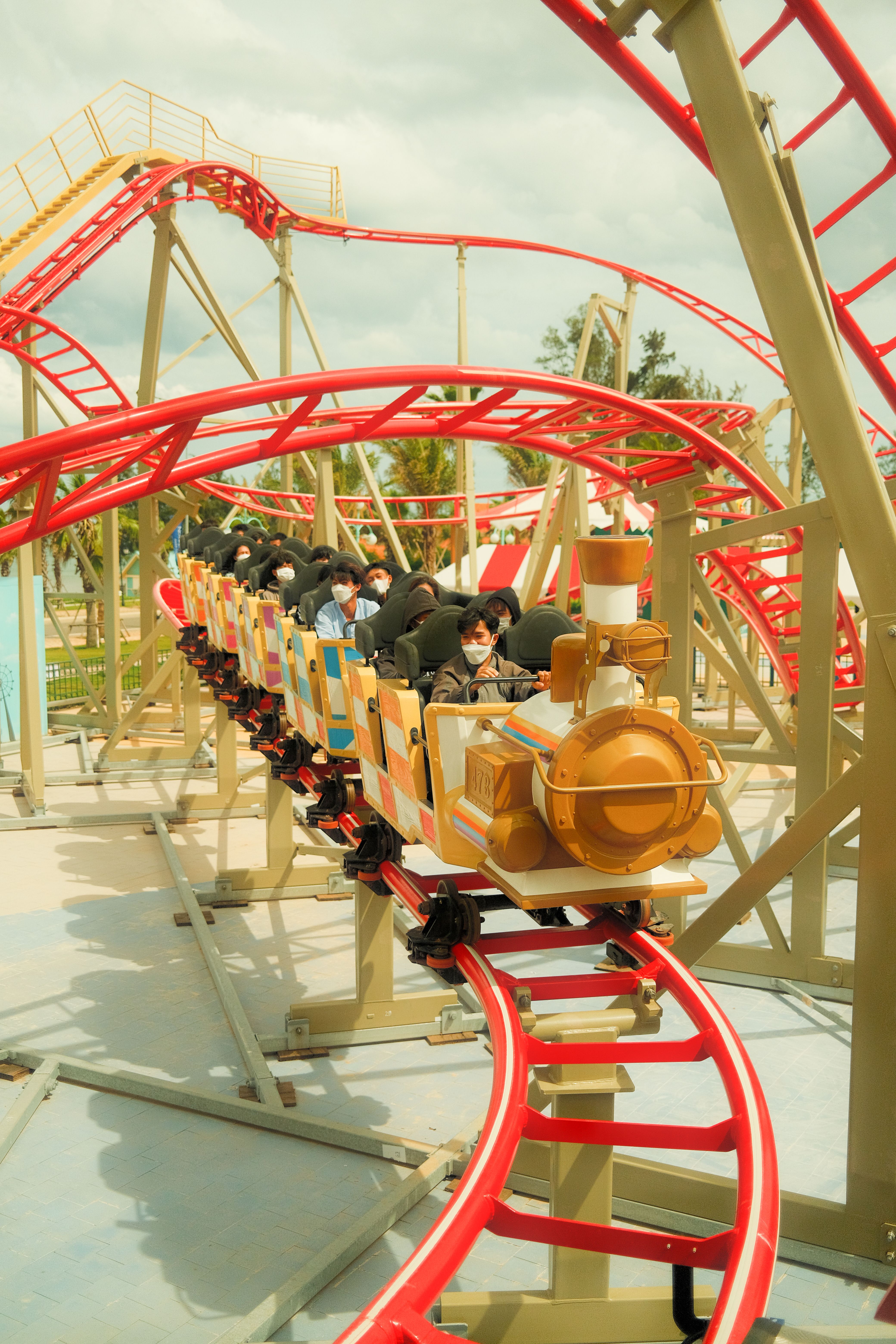 Family enjoying a theme park ride on a sunny day